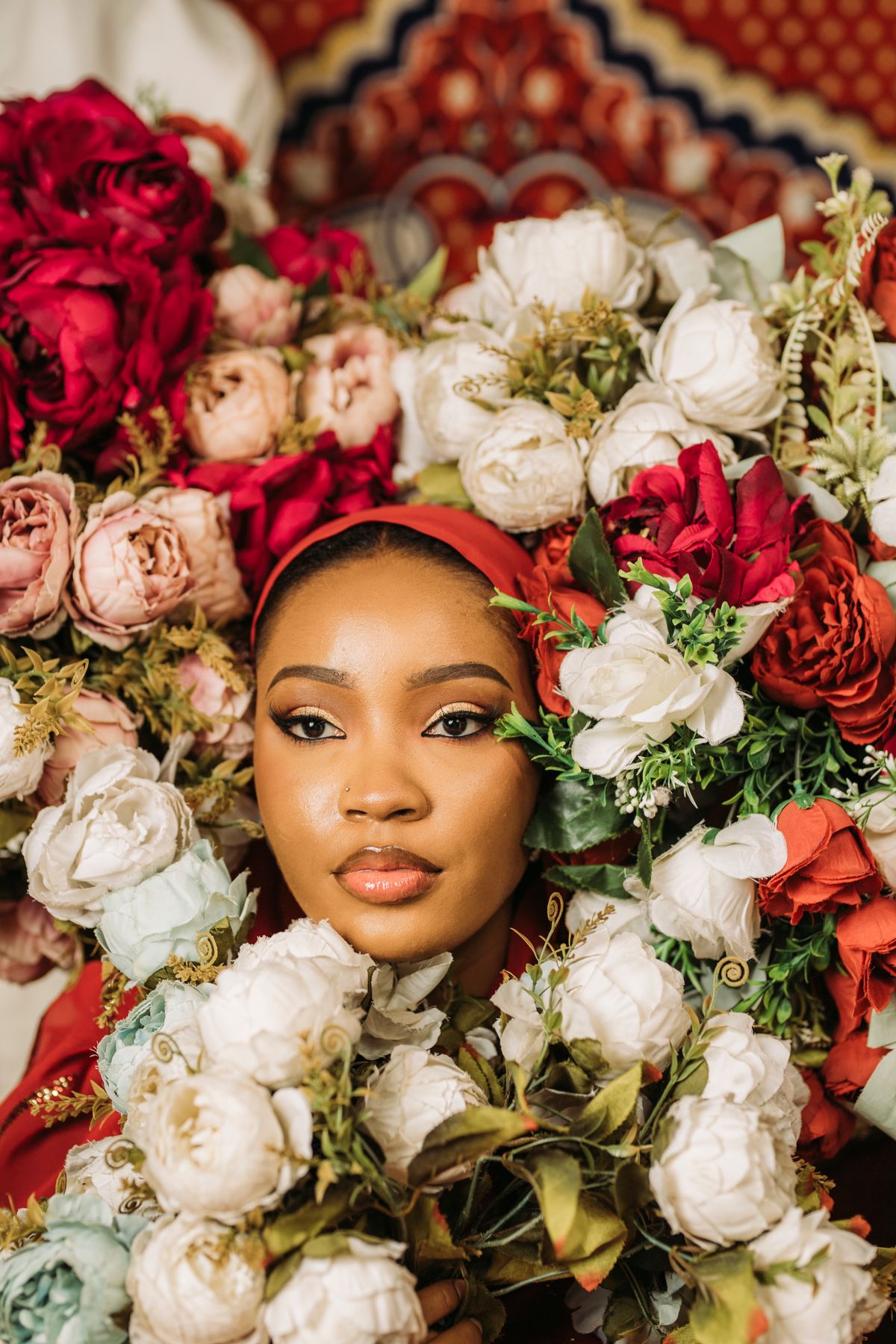 Captivating portrait of a woman surrounded by vibrant flowers, exuding grace and beauty.